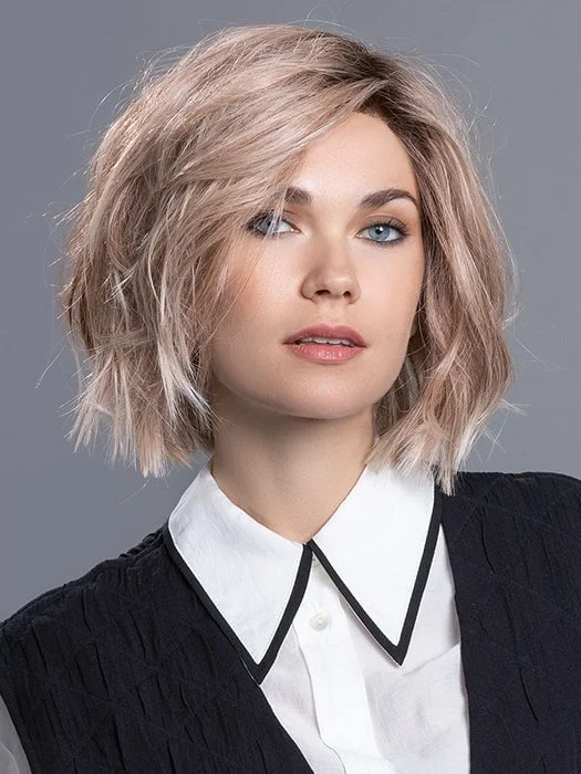 Short wig with a curly texture for a playful and youthful vibeLia II | Heat Friendly Synthetic Lace Front (Mono Part) Wig by Ellen Wille